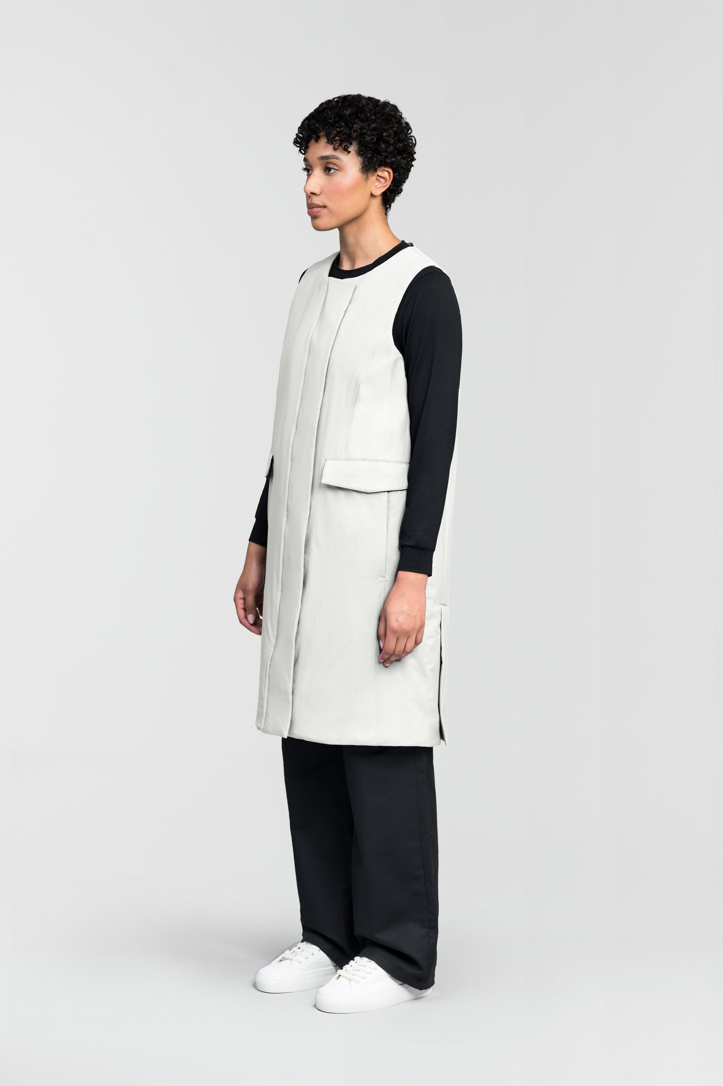 Brexton Women's Tailored Long Mid Layer Vest in knee length, centre front wind flap, flap closure waist pocket with additional side entry storage, single vent on back bottom hem, in Chalk