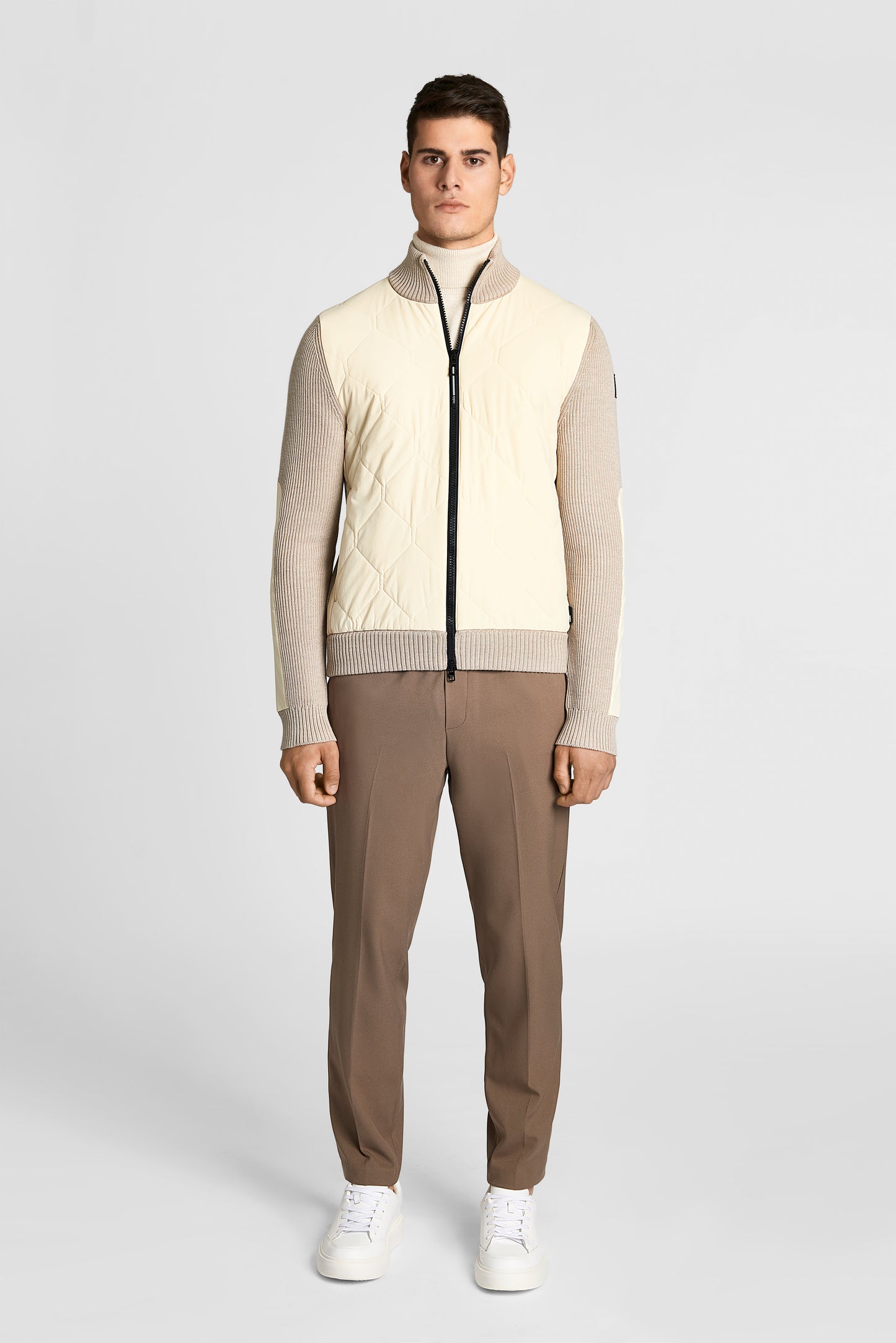 Ero Men's Tailored Hybrid Sweater in hip length, PrimaLoft Gold Insulation Active+, Durable 4-Way Stretch Weave quilted torso, Merino wool knit collar, sleeves, back, and cuffs, two-way front zipper, and hidden waist pockets, in Wheat