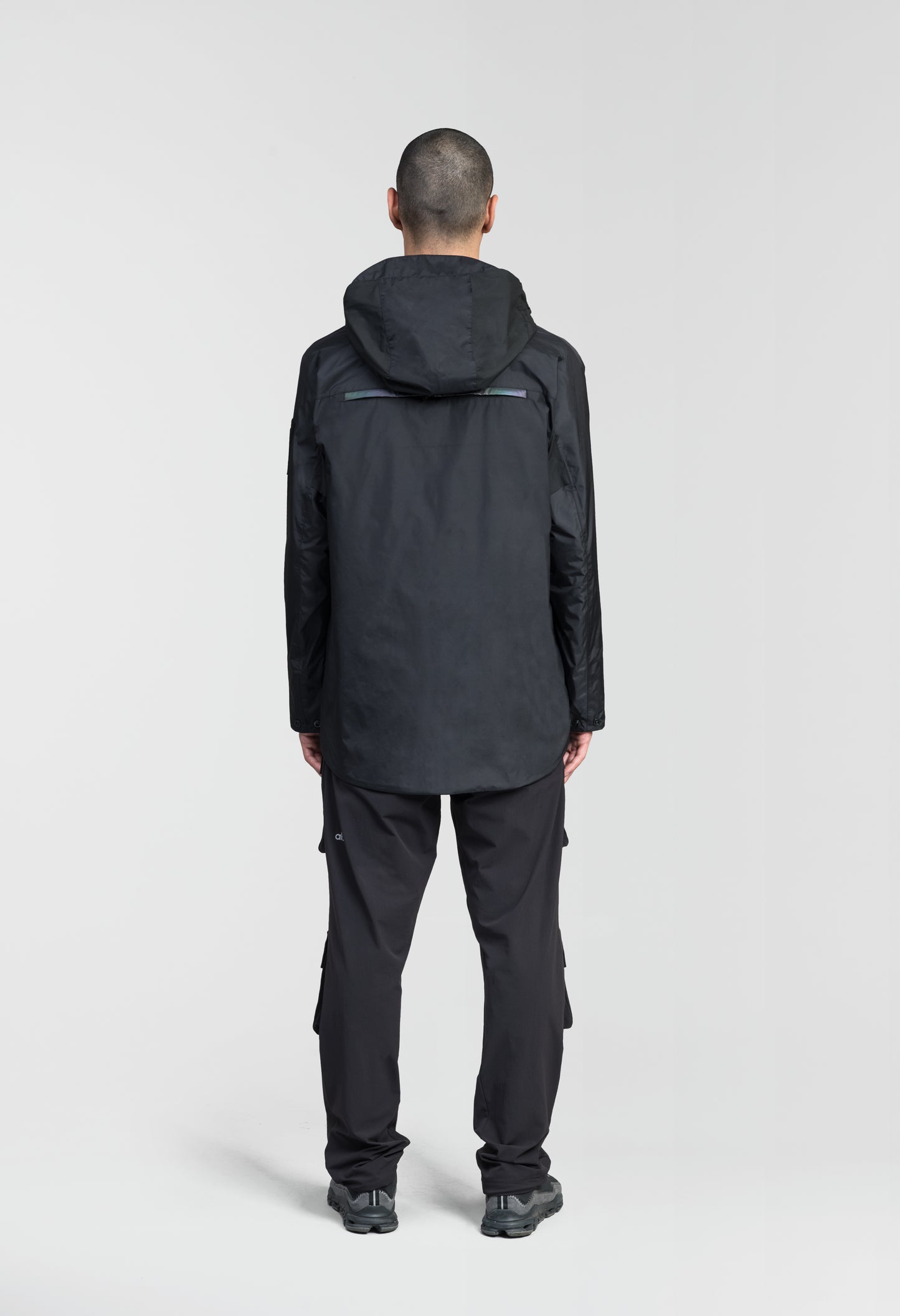 Mission Men's Performance Rain Shell Jacket in hip length, non-removable hood with adjustable toggle, two-way waterproof zipper, flap closure waist pockets with additional side entry storage, zipper ventilation on back, passive underarm ventilation, and breathable mesh lining, in Black