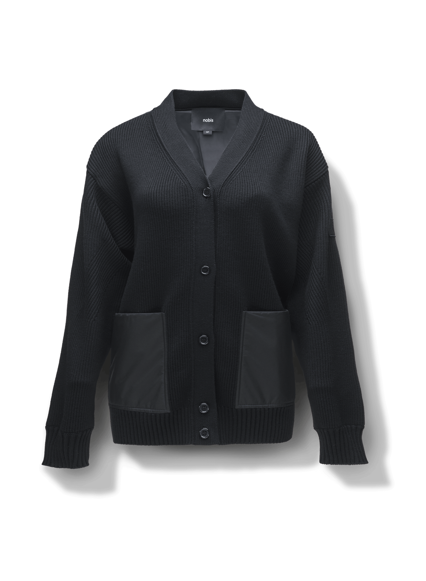 Riga Tailored Button Front Cardigan in thigh length, premium virgin extra fine merino wool knit and stretch ripstop fabrication, Primaloft Gold Insulation Active+, button-front closure, quilted back detailing, front waist pockets, in Black