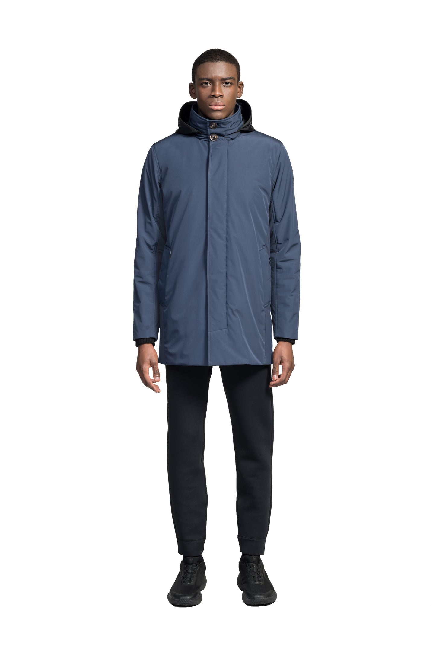 Pike Men's Tailored Mac Coat in thigh length, premium 3-ply Micro Denier fabrication at body and cire technical nylon taffeta fabrication at hood, premium 4-way stretch, water resistant Primaloft Gold Insulation Active+, hidden 2-way zipper with snap closure wind flap, single welt pockets with magnetic closure at waist, hidden snap placket at cuffs, pit zippers for ventilation, interior zipper pocket at right chest, and interior button pocket at left chest, in Marine