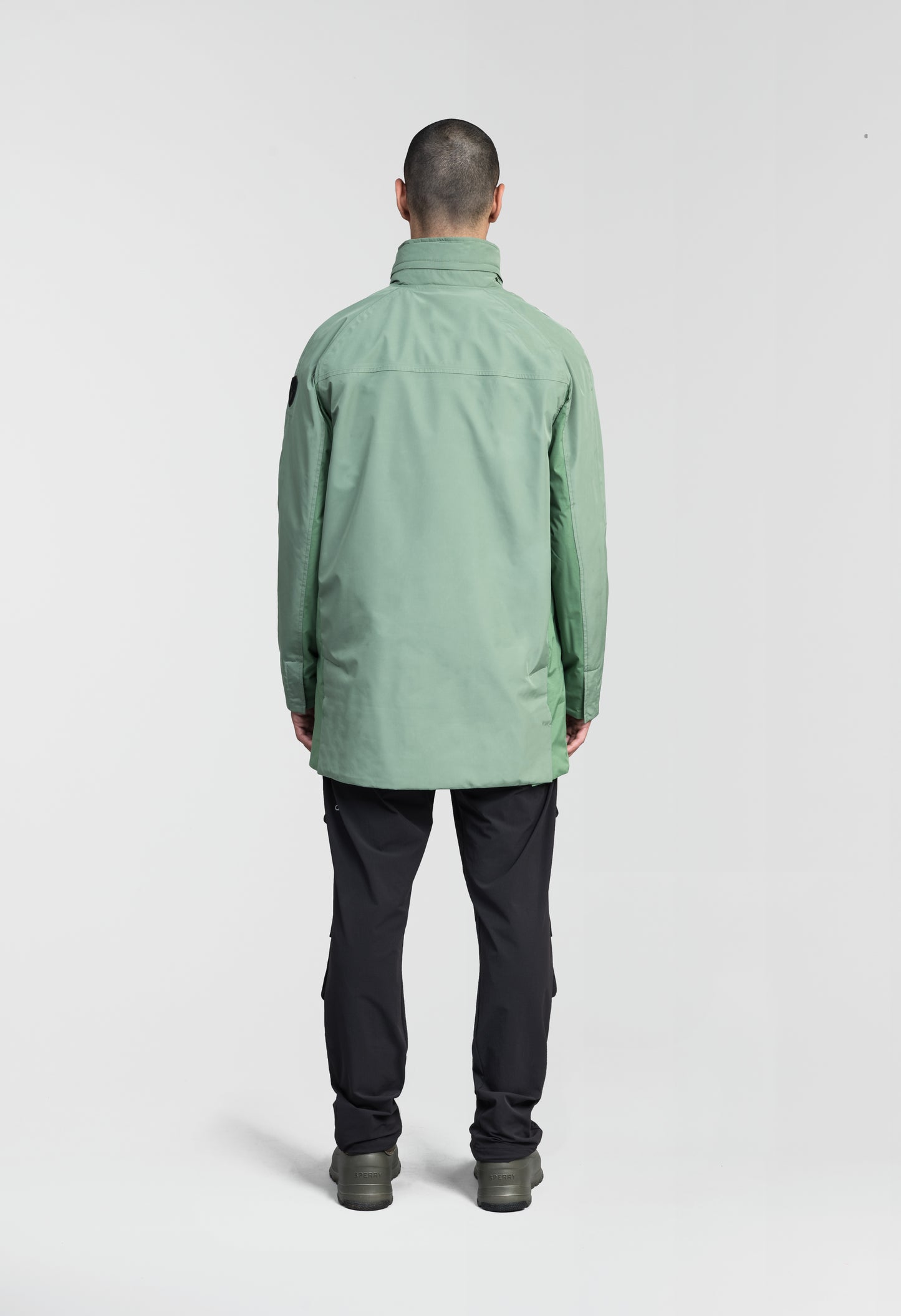 Pike Men's Tailored Mac Coat in thigh length, premium 3-ply Micro Denier fabrication at body and cire technical nylon taffeta fabrication at hood, premium 4-way stretch, water resistant Primaloft Gold Insulation Active+, hidden 2-way zipper with snap closure wind flap, single welt pockets with magnetic closure at waist, hidden snap placket at cuffs, pit zippers for ventilation, interior zipper pocket at right chest, and interior button pocket at left chest, in Comfrey