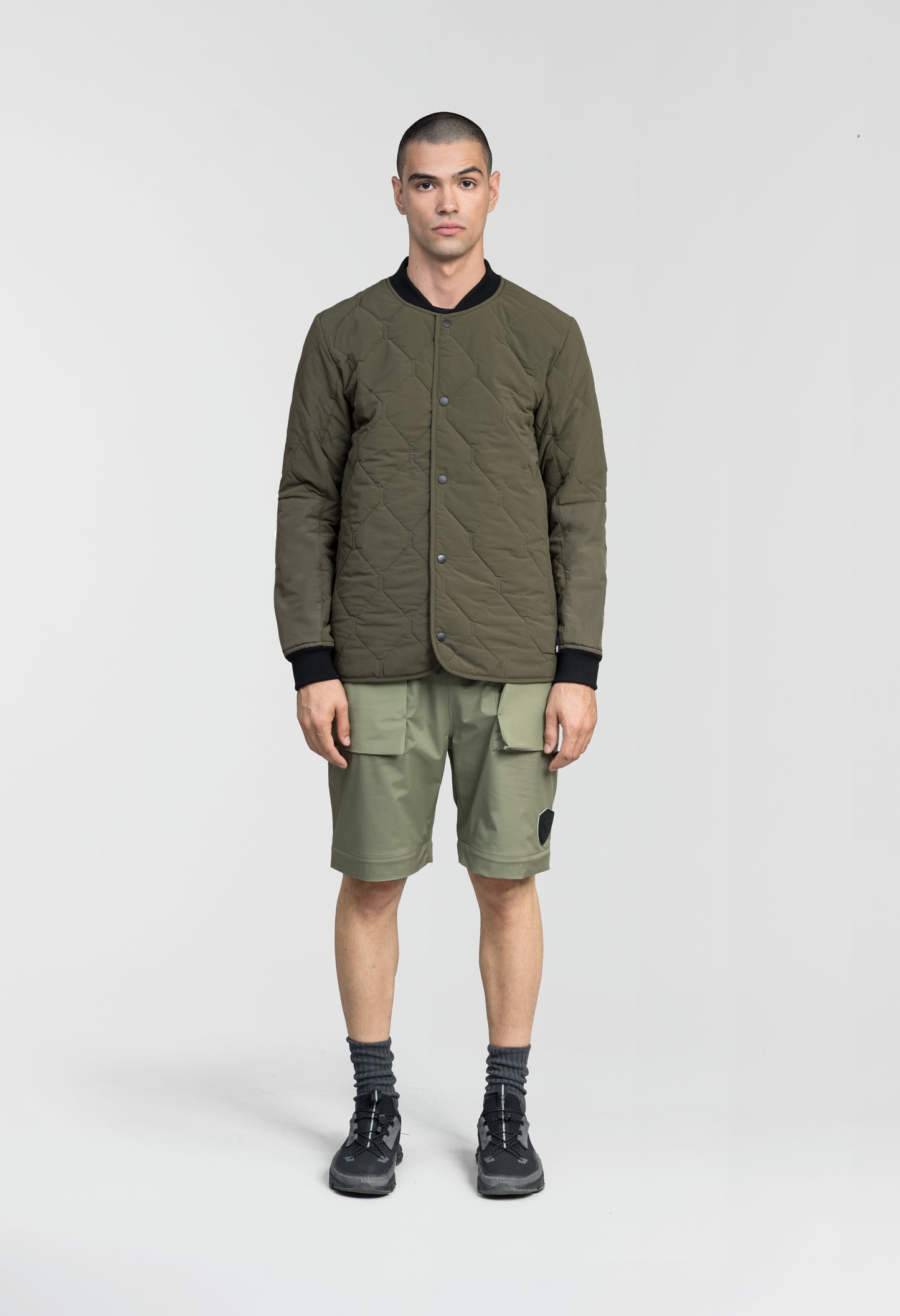 Speck Men's Tailored Mid Layer Jacket in hip length, Primaloft Gold Insulation Active+, diamond quilted body, rib knit collar and cuffs, snap buton front closure, and hidden side-entry zipper pockets at waist, in Fatigue
