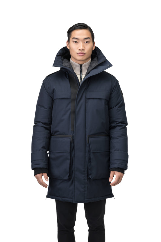 Alum Men's Long Parka in thigh length, Premium Canadian White Duck Down insulation, non-removable hood with removable coyote fur trim, two-way centre front zipper with magnetic closure wind flap, four exterior patch pockets at front, in Navy + Navy / XS