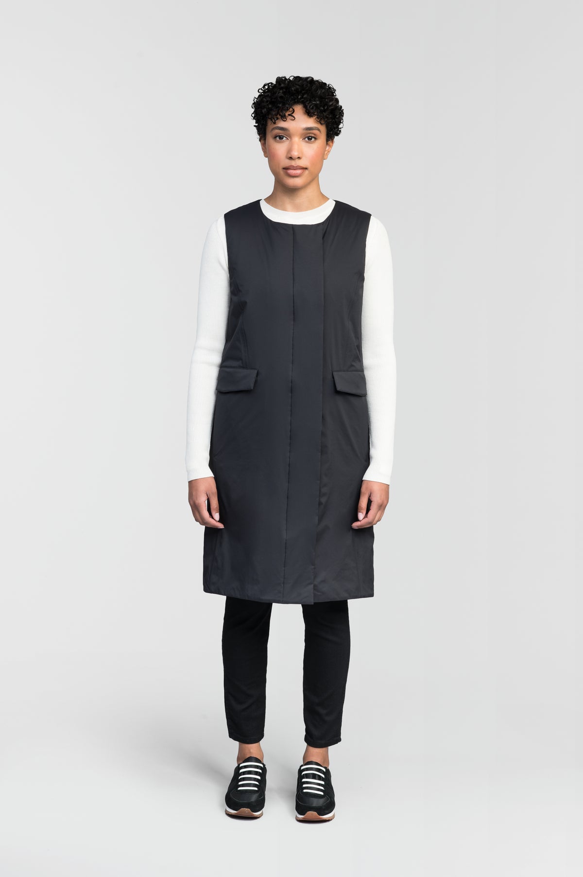 Brexton Women's Tailored Long Mid Layer Vest in knee length, centre front wind flap, flap closure waist pocket with additional side entry storage, single vent on back bottom hem, in Black