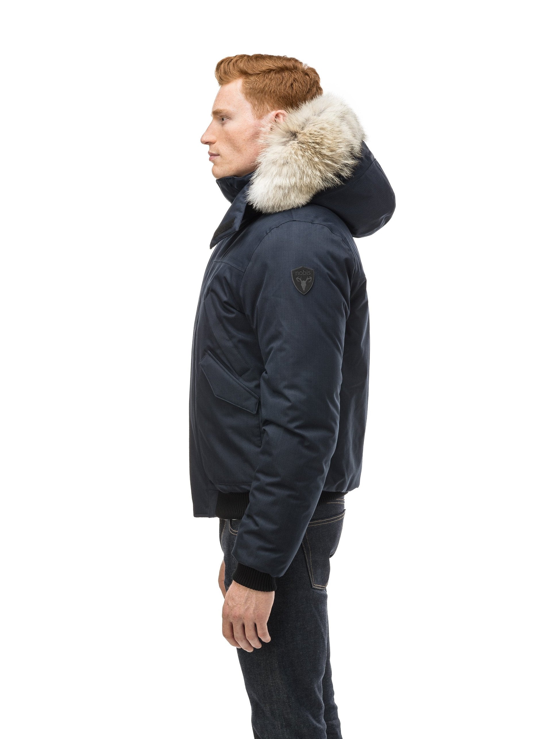Men's classic down filled bomber jacket with a down filledÃƒÆ’Ã†â€™Ãƒâ€ Ã¢â‚¬â„¢ÃƒÆ’Ã‚Â¢ÃƒÂ¢Ã¢â‚¬Å¡Ã‚Â¬Ãƒâ€¦Ã‚Â¡ÃƒÆ’Ã†â€™ÃƒÂ¢Ã¢â€šÂ¬Ã…Â¡ÃƒÆ’Ã¢â‚¬Å¡Ãƒâ€šÃ‚Â hood that features a removable coyote fur trim and concealed moldable framing wire in Navy