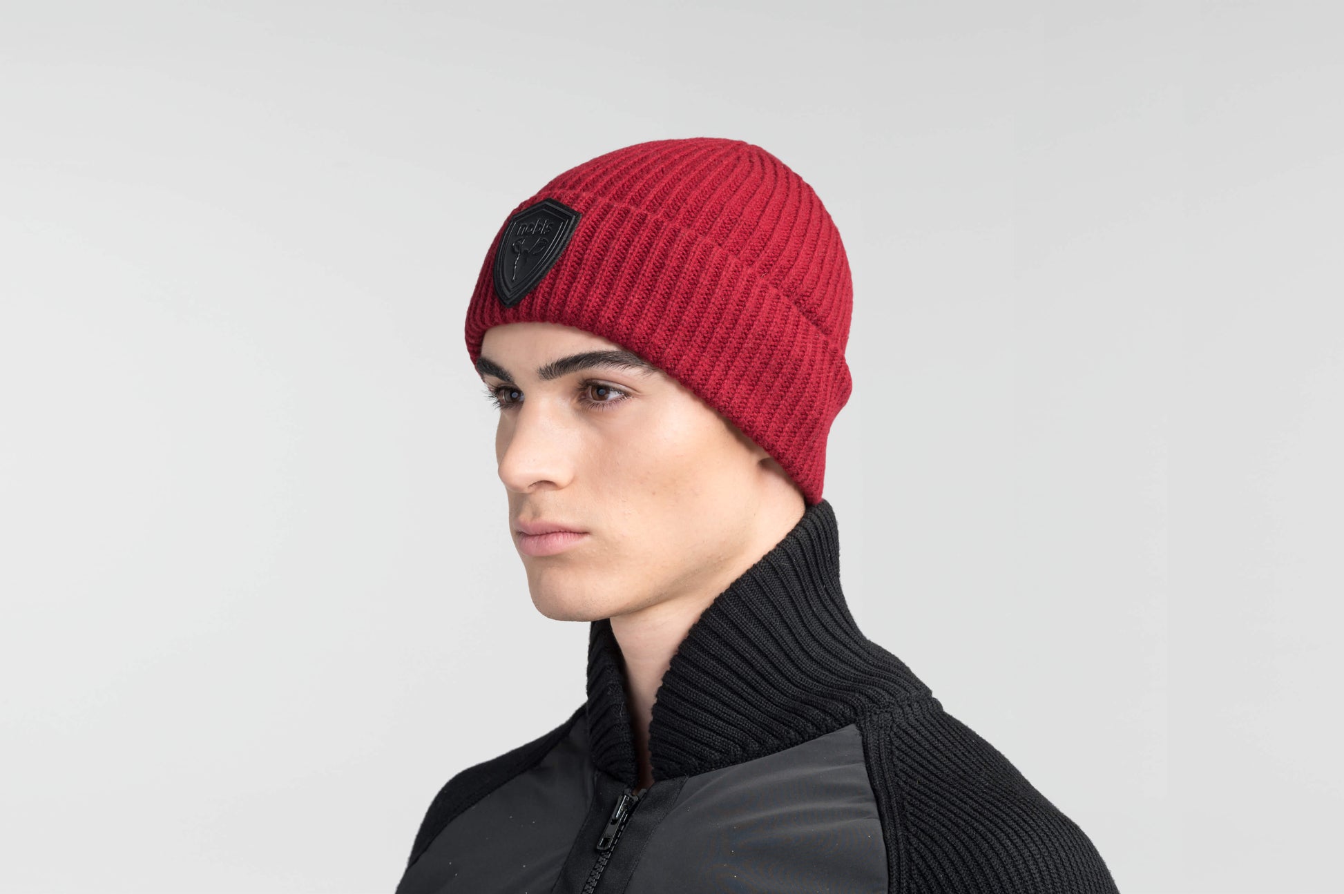 Emer Unisex Tailored Chunky Knit Beanie in extra fine merino wool blend, and black leather Nobis shield logo on cuff, in Rio Red