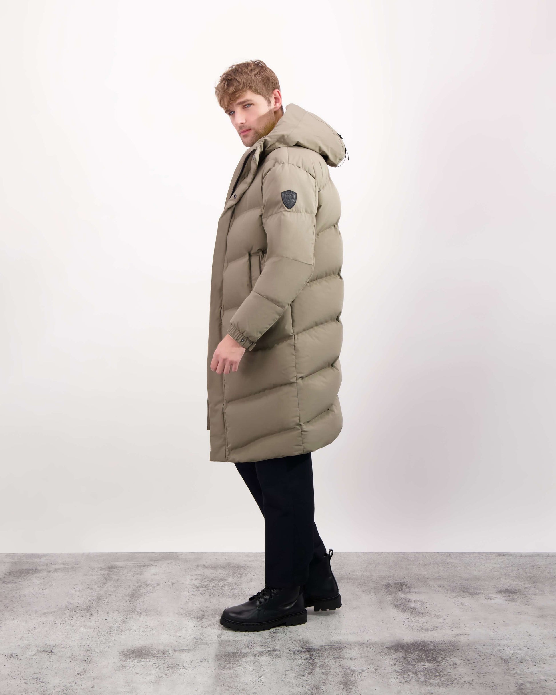 Granger long jacket in Bungee Cord stretch ripstop fabric with DWR coating, insulated with Canadian white duck down and Primaloft. Features a two-way zipper, magnetic closure, and adjustable cuffs for warmth and weather protection.