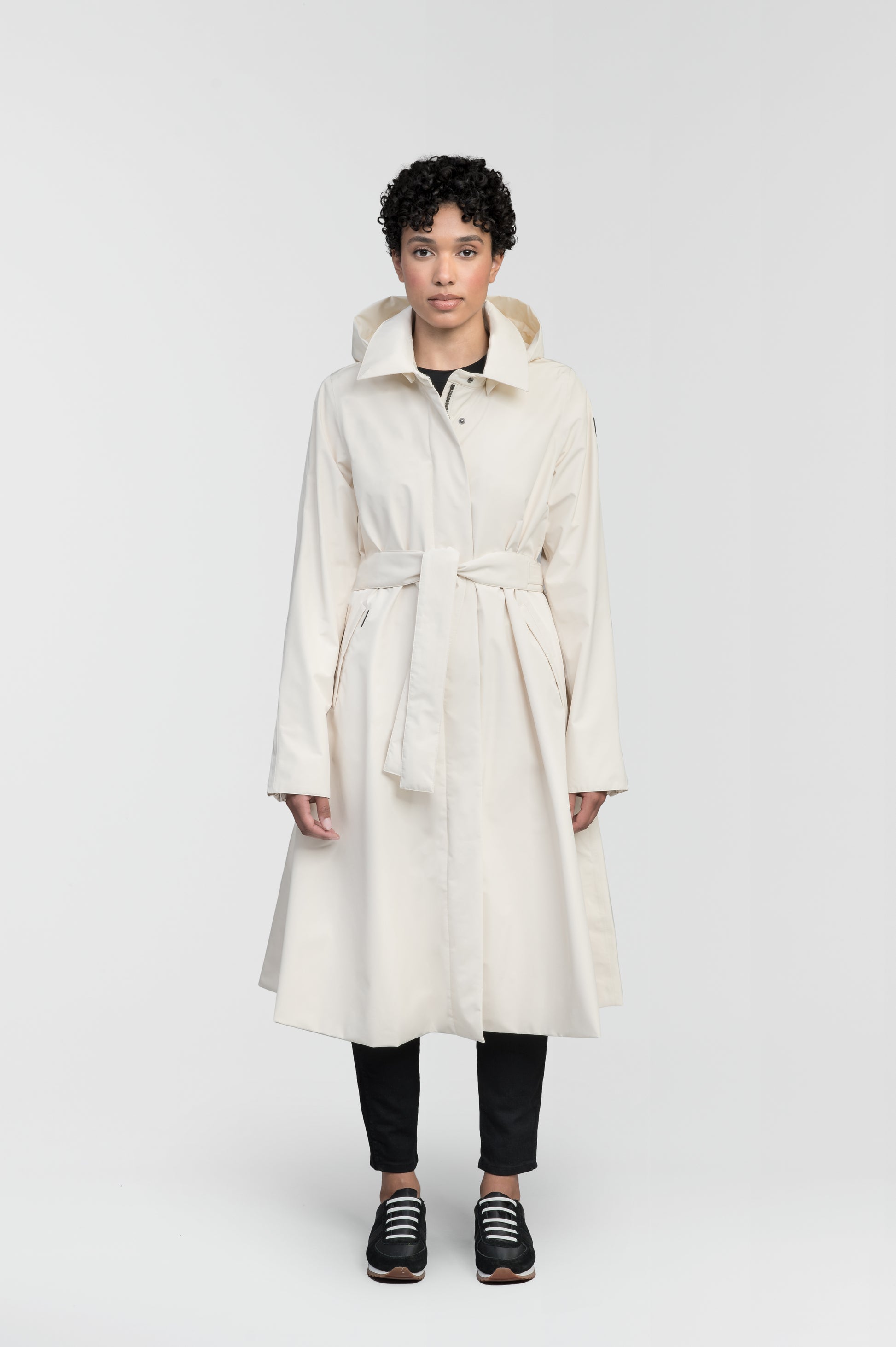 Ivy Ladies Tailored Trench Coat in knee length, 3-Ply Micro Denier fabrication, retractable non-removable hood, front wind flap with snap button closure, removable belt, and adjustable snap cuffs, in Wheat