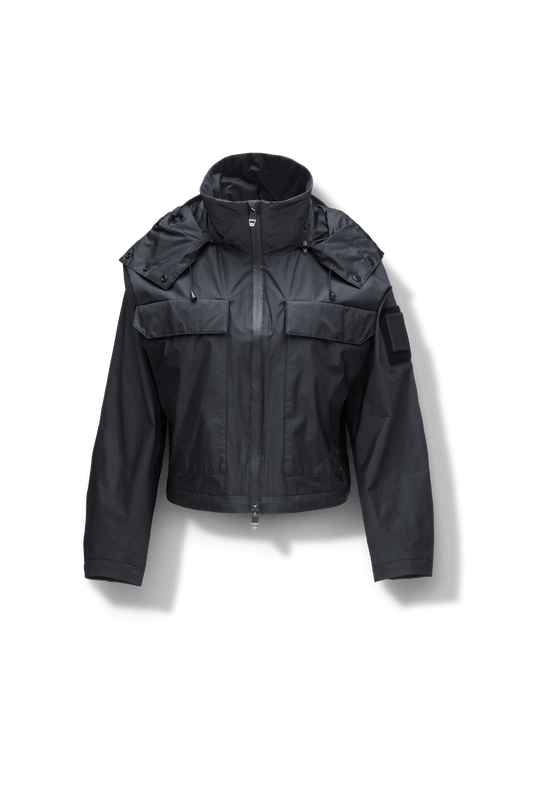Viva Women's Performance Cropped Jacket in waist length, premium iridescent fabrication, removable hood with peak, adjustable hood draw cords and toggle, 2-way branded zipper at centre front, oversized magnetic closure flap pockets at chest with side entry, interior adjustable draw cord at hem, large interior zipper pocket, and adjustable snap cuffs, in Black + Black