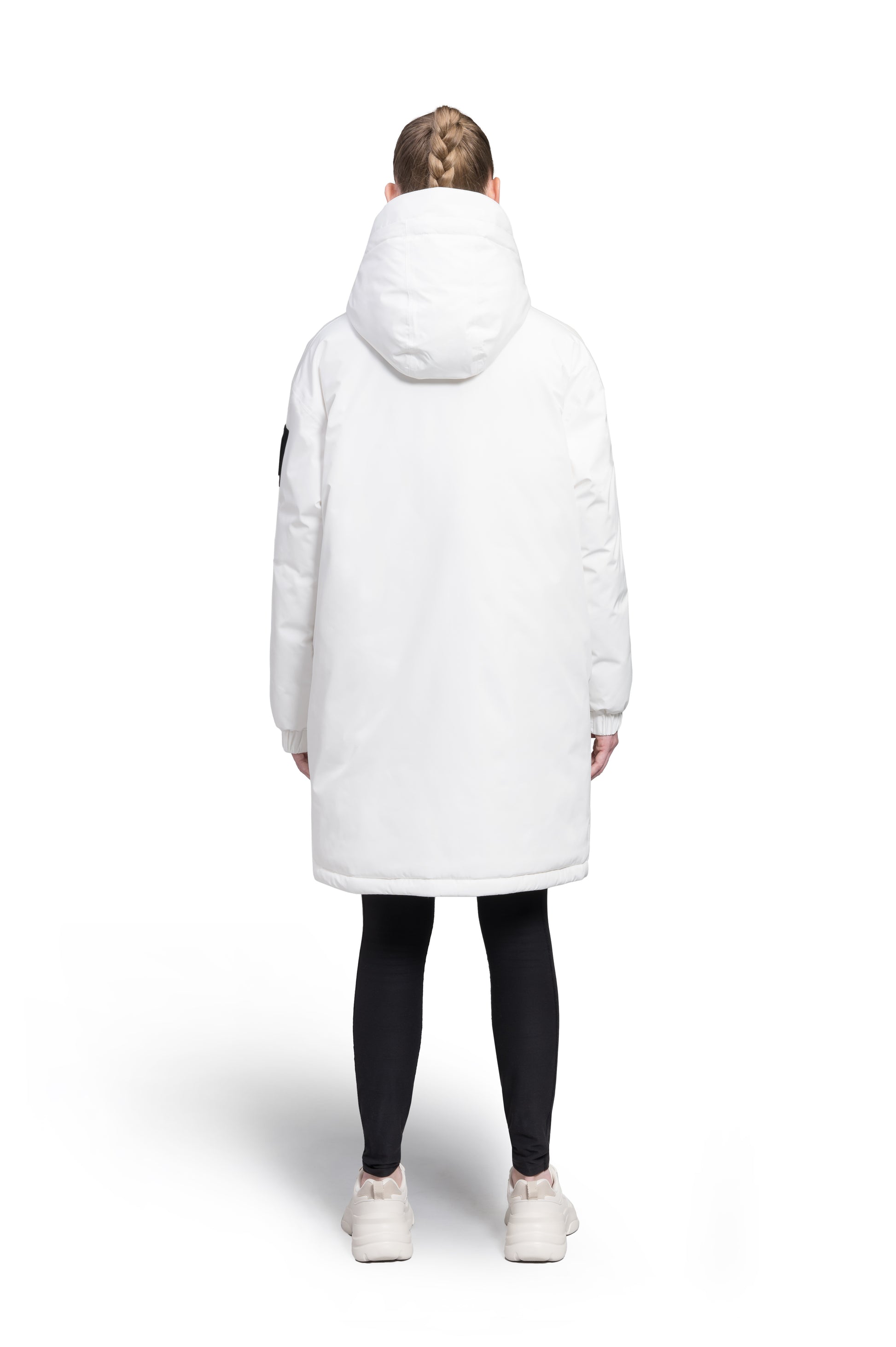Slyn Women's Performance Parka in thigh length, premium 3-ply micro denier and cire technical nylon taffeta fabrication, Premium Canadian origin White Duck Down insulation, non-removable down-filled hood, inner hooded gilet, two-way centre-front zipper with magnetic closure wind flap, fleece-lined pockets at chest and waist, pit zipper vents, in Chalk