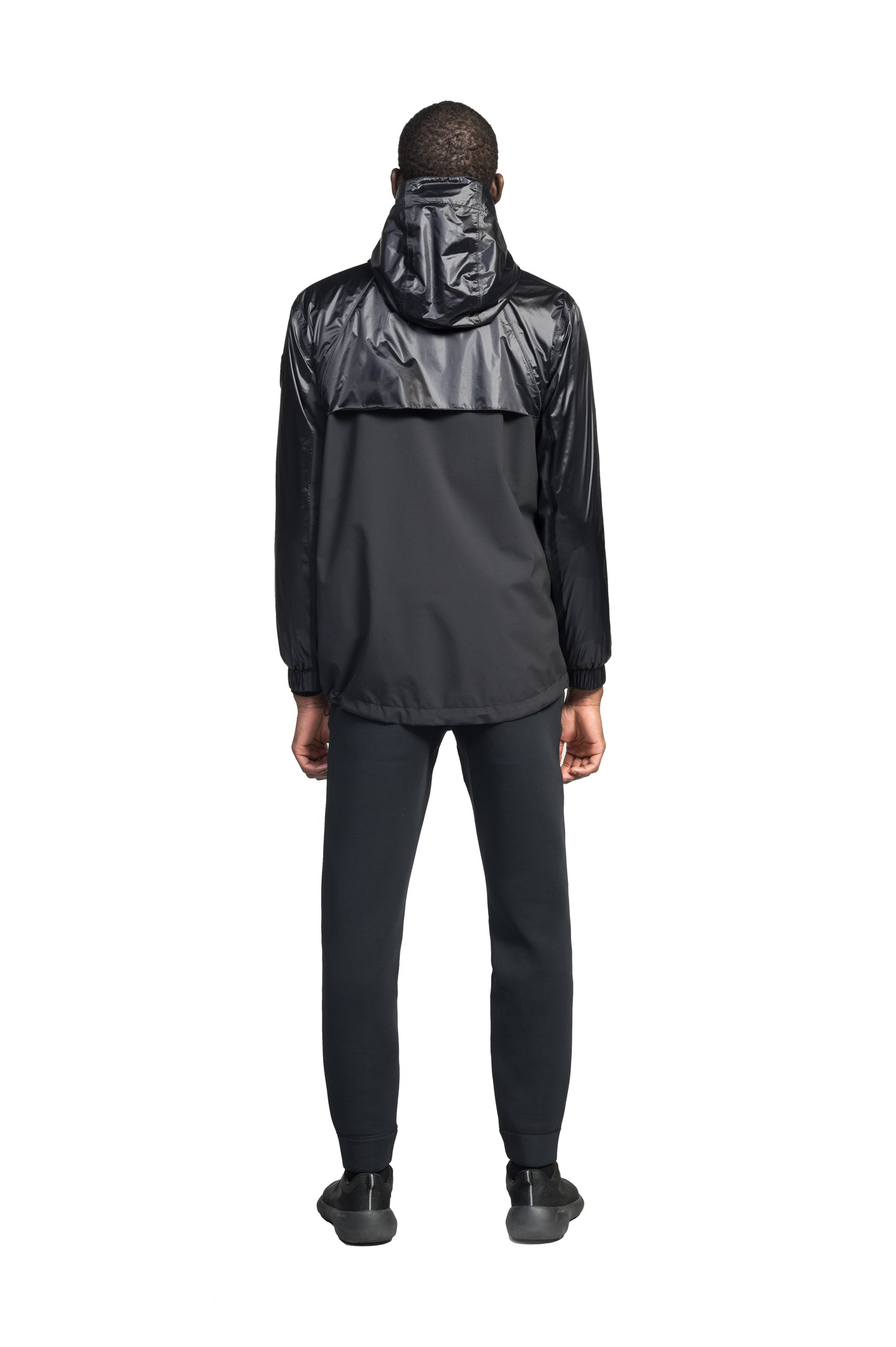 Stratus Men's Tailored Packable Rain Jacket in hip length, premium cire technical nylon taffeta and stretch ripstop fabrication, highly breathable mesh lining, hidden packable pocket, non-removable hood with adjustable draw cord, reflective piping along front and back, underarm grommets for extra breathability, back yoke with mesh ventilation, two waist zipper pockets, two interior zipper pockets, elastic cuffs with adjustable snap button, and adjustable interior draw cord at waist hem, in Black