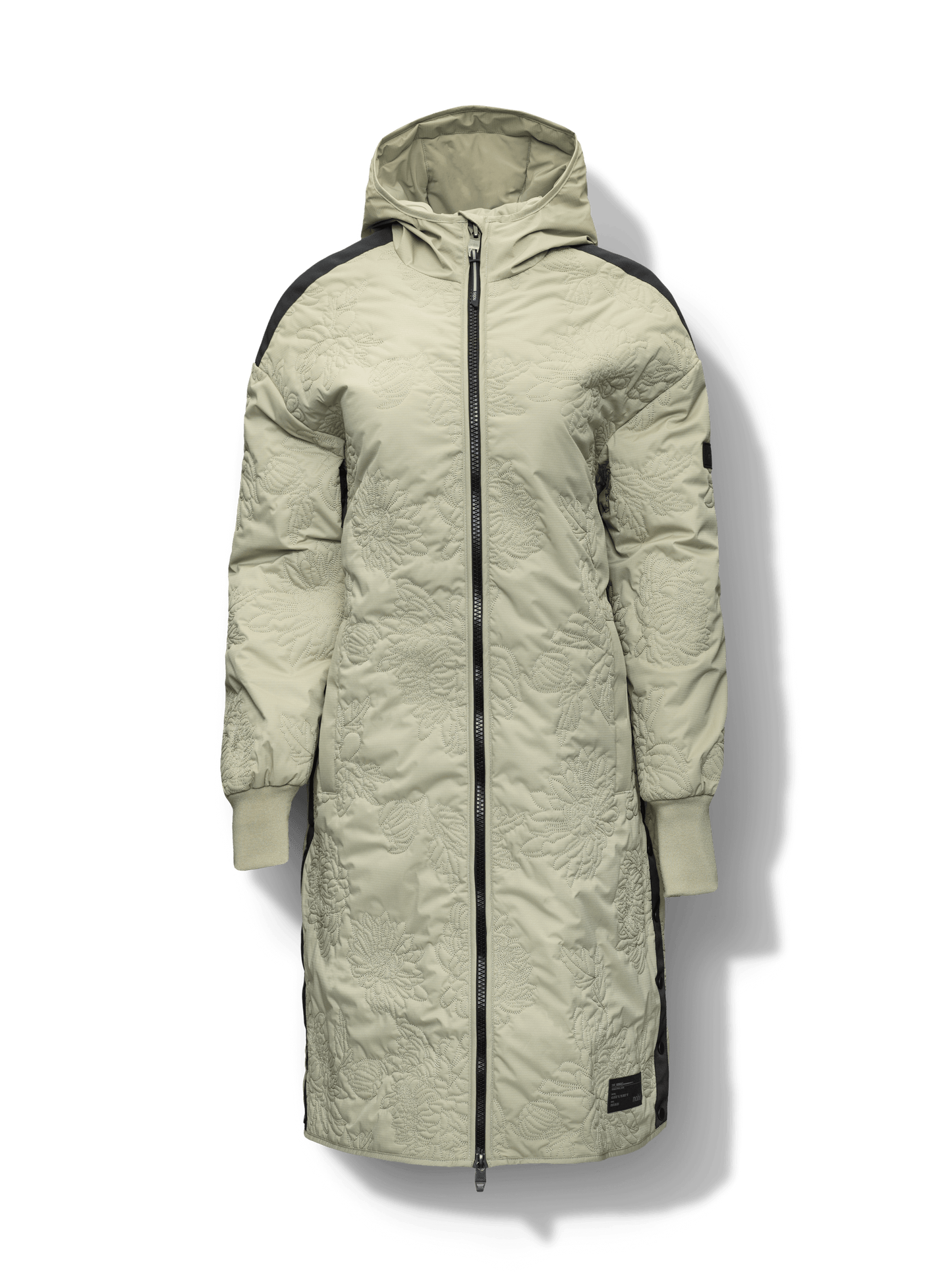 Surrey Women's Performance Quilted Long Mid Layer Jacket in knee length, Primaloft Gold Insulation Active+, non-removable hood, single welt magnetic closure pockets, ribbed cuffs, two-way centre front zipper, grosgrain ribbon detail and shoulders and side seam, and snap closure side seam vents, in Tea