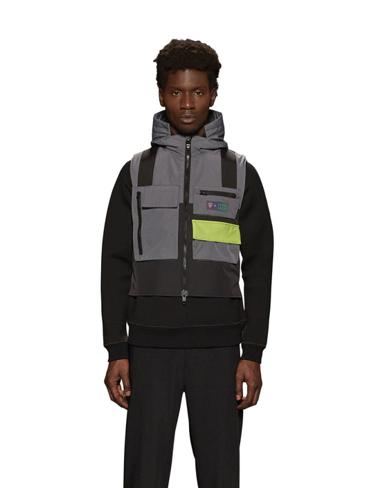 Unisex waist length hooded tactical vest with multiple exterior pockets on front and back, and adjustable side webbing fasteners, colour blocked in Concrete/Black + Concrete/Black