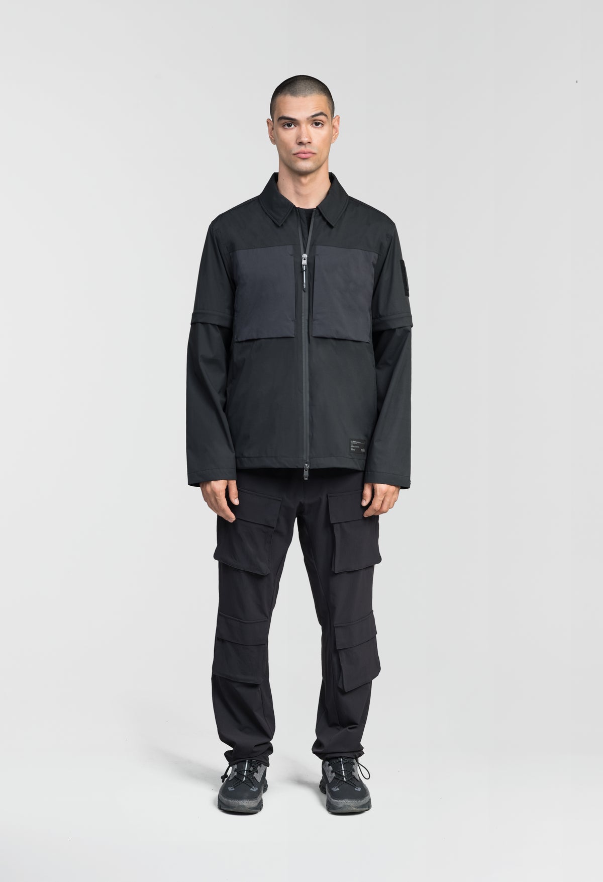 Thurlow Men's Performance Zip Off Sleeve Rain Shirt in hip length, convertible collar, patch chest zipper pockets, hidden in-seam pockets, zip off sleeves, centre front two-way zipper closure, in Black
