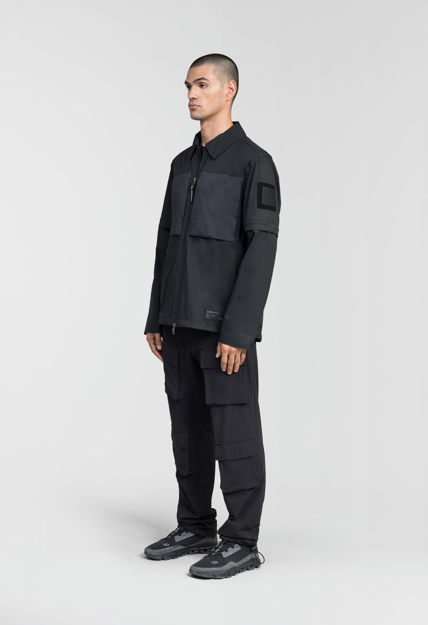 Thurlow Men's Performance Zip Off Sleeve Rain Shirt in hip length, convertible collar, patch chest zipper pockets, hidden in-seam pockets, zip off sleeves, centre front two-way zipper closure, in Black
