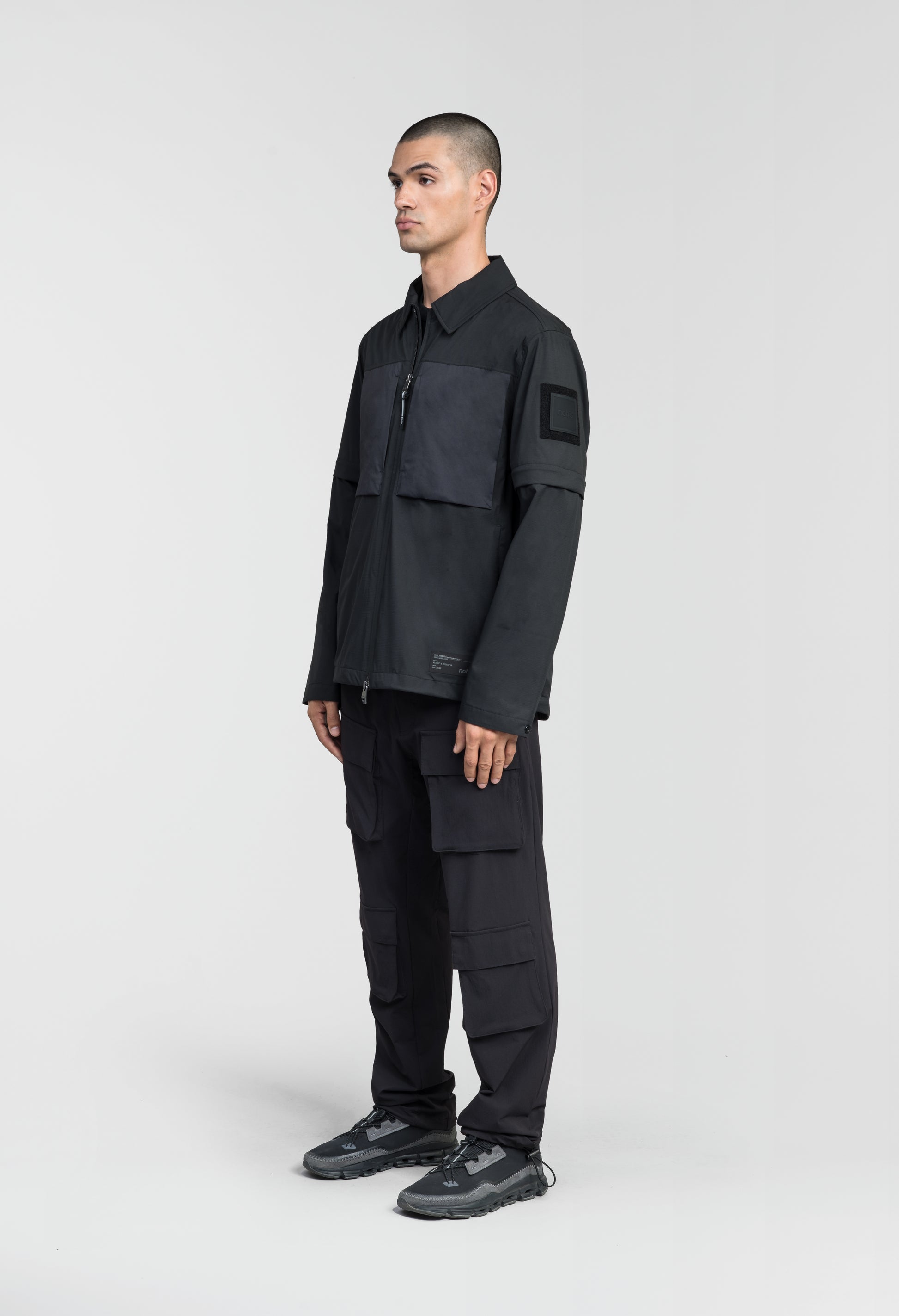 Thurlow Men's Performance Zip Off Sleeve Rain Shirt in hip length, convertible collar, patch chest zipper pockets, hidden in-seam pockets, zip off sleeves, centre front two-way zipper closure, in Black