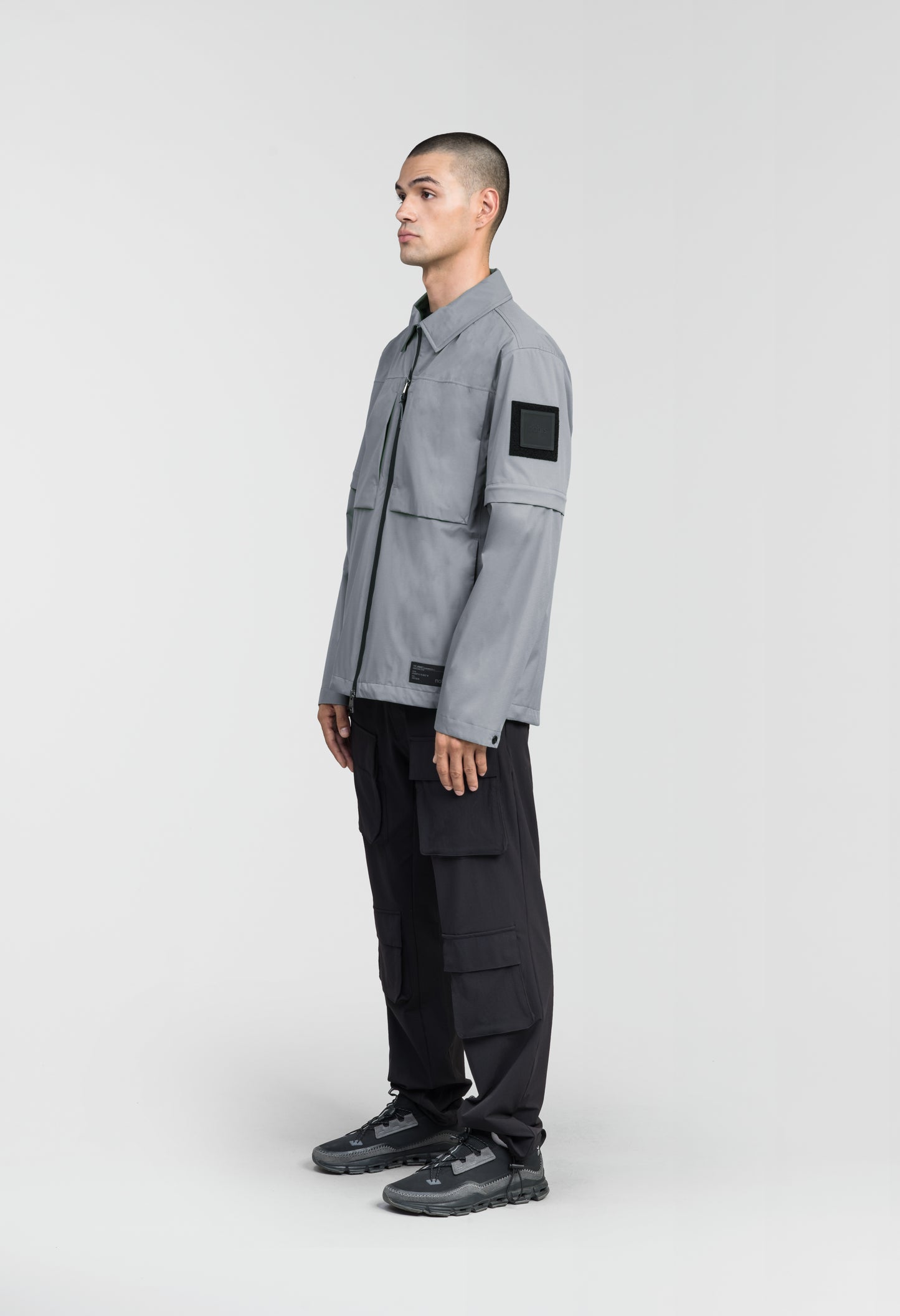 Thurlow Men's Performance Zip Off Sleeve Rain Shirt in hip length, convertible collar, patch chest zipper pockets, hidden in-seam pockets, zip off sleeves, centre front two-way zipper closure, in Concrete