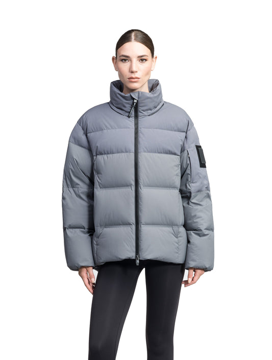 Una Ladies Performance Puffer in hip length, Technical Taffeta and Durable Stretch Ripstop fabrication, Premium Canadian White Duck Down insulation, removable down filled hood, centre front two-way zipper, and side-entry pockets at waist, in Concrete + Concrete / XXS